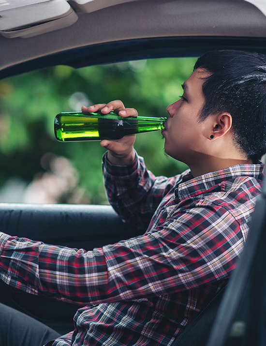 Man driving while drinking
