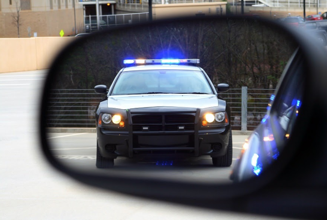 rearview mirror showing a police car
