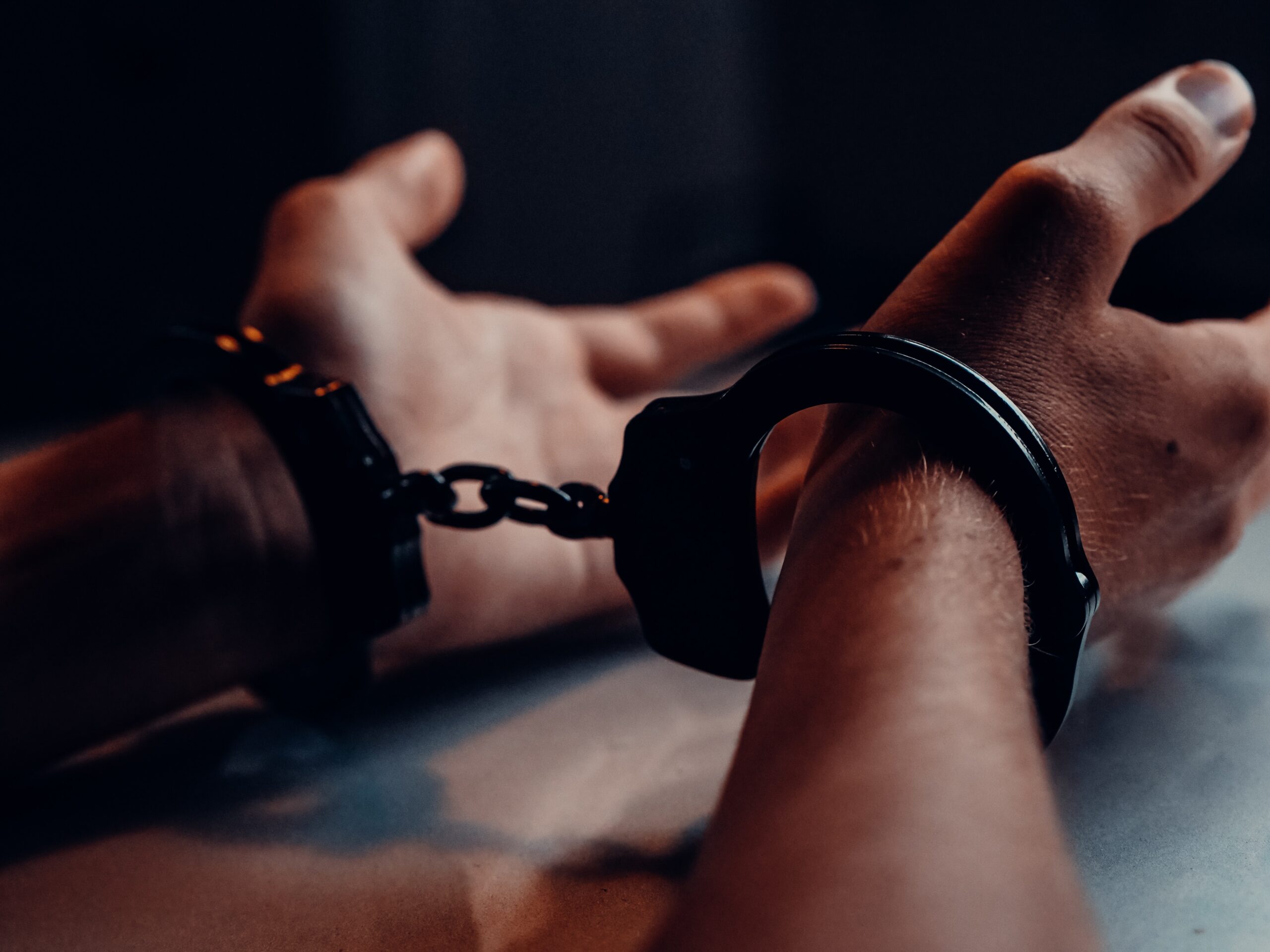 a person's hands in handcuffs